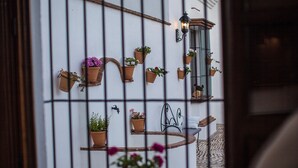 A wall with multiple potted plants and a metal railing. - Villa 'El Arroyo Ronda' with Mountain View, Wi-Fi and Air Conditioning (Ronda)