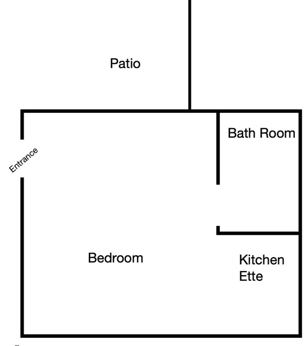 Een plattegrond met een terras, ingang, slaapkamer, badkamer en kitchenette.
