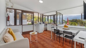 A modern kitchen with a dining area, large windows, and a view of the outdoors. - Vacation 'Beautiful Sea View and Pool Finca 3' with Shared Pool, Private Terrace and Wi-Fi (Adeje)