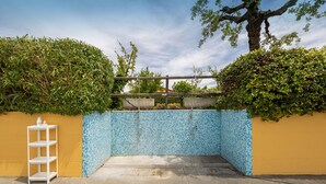 A gated entrance with a tiled wall, a metal gate, and a white shelf. - Apartment 'Casa Milla - Bilocale Becaccia' with Shared Pool, Shared Terrace and Wi-Fi (Cecina)