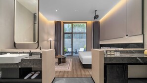 A modern hotel bathroom with two sinks, a large mirror, and a view of the outdoors. - Songmo Hotel (Huzhou)