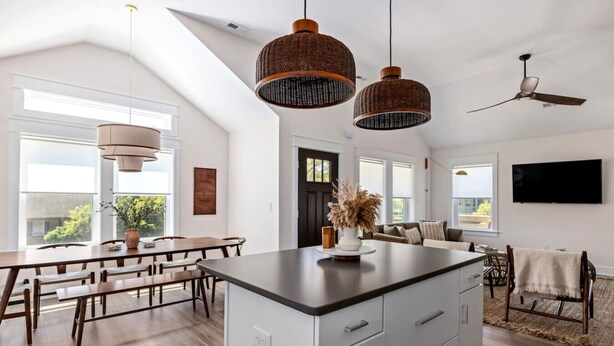 A spacious kitchen with a large island, pendant lights, and a ceiling fan. - Wave Haven - Bali Style! Hot Tub! Near Bay & Beach (Kill Devil Hills)