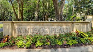 A sign reading "Windsor Place" with a landscaped garden in front.