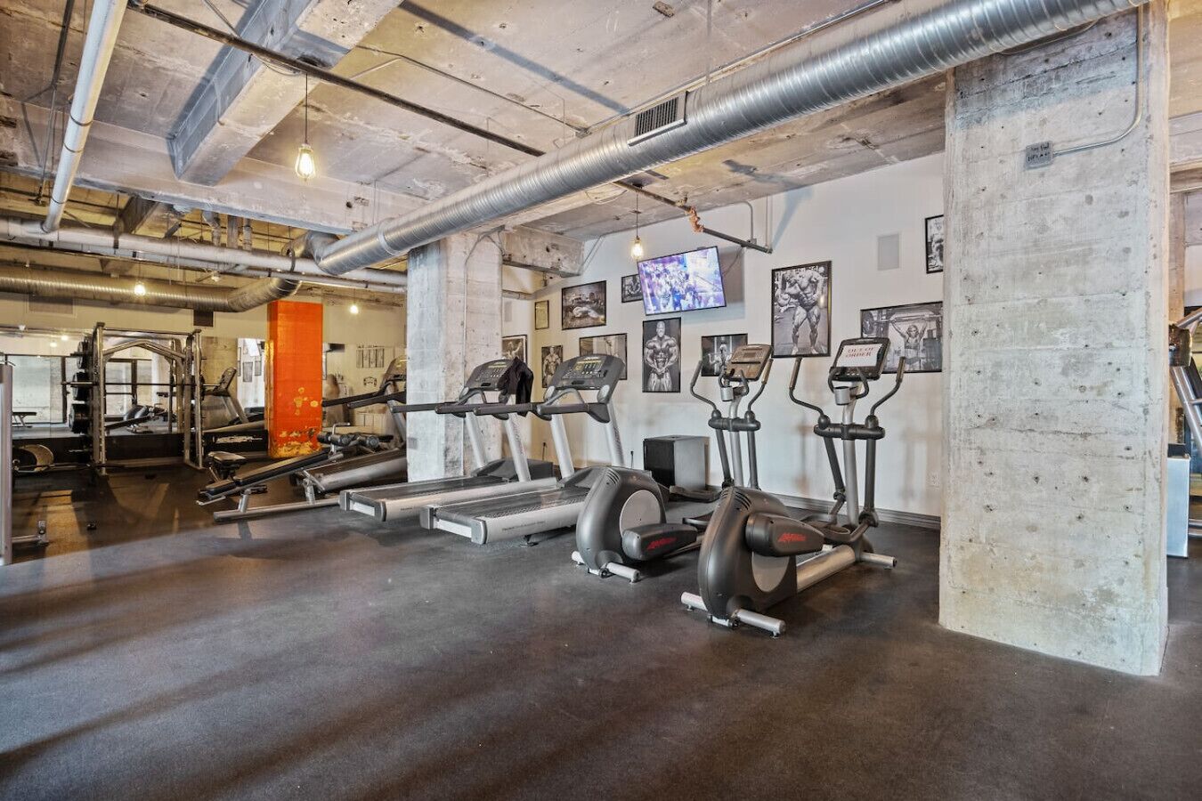 A gym with treadmills, ellipticals, and weight machines.