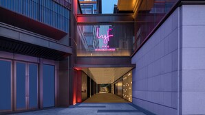A modern building with a neon sign reading "lyf" and "BY THE ASCOTT LIMITED". - lyf Xian Dayanta by Ascott (Xi'an)