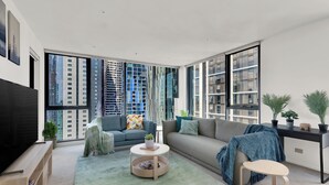 A modern living room with a large TV, comfortable seating, a coffee table, and large windows offering city views. - Nook Melbourne - Zen Apartments (Melbourne)