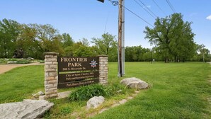 A sign for Frontier Park with a stone pillar, located at 500 S. Riverside Dr., managed by the City of Saint Charles, MO. - Steps to Downtown-Boutique Comfort- Bear Suite (Saint Charles)