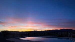 A swimming pool with a view of mountains during sunset. - Ridgeline Oasis! (Bullhead City)