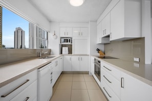 Deluxe Apartment, 2 Bedrooms, Balcony, Ocean View | Private kitchen | Electric kettle, toaster, cleaning supplies, freezer - Absolute Beachfront Apartment in Surfers (Surfers Paradise)