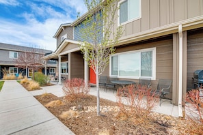 Enjoy outdoor seating areas with chairs and tables, surrounded by a beautifully landscaped garden.