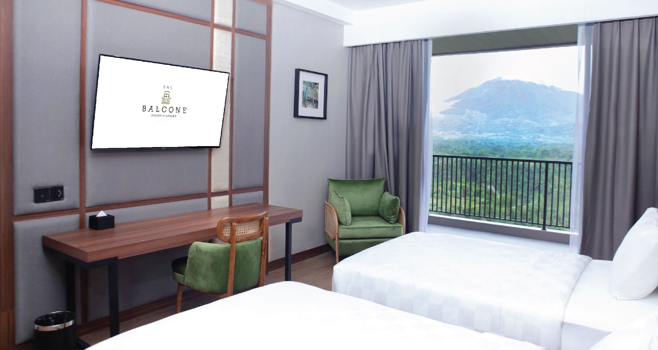 A hotel room with a bed, a desk, a chair, a TV, and a balcony with a mountain view.