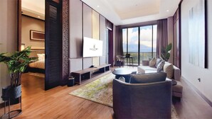 A modern hotel room with a large bed, a seating area with a coffee table, and a balcony with a view. - The Balcone Hotel & Resort (Bukittinggi)