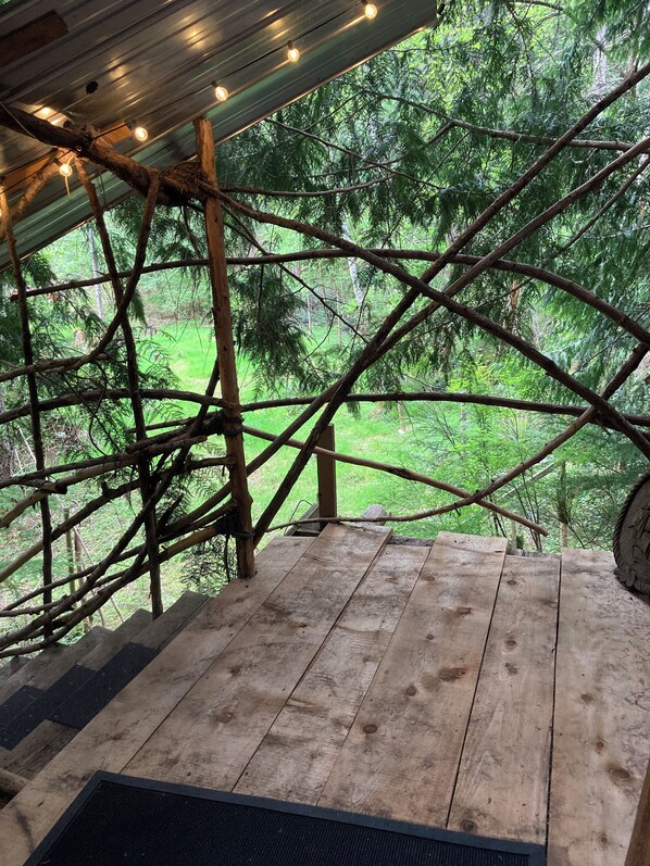A wooden deck with a view of a forest. - Unique Cortes Treehouse! - Peaceful haven in the trees (Strathcona B)