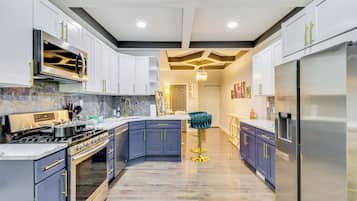 A modern kitchen with a built-in stove, oven, and refrigerator.