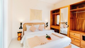 A bedroom with a large bed, wooden wardrobe, and bedside lamps. - Exquisite 2 Bedroom Retreat Nestled In The Serene Pecatu (pecatu)