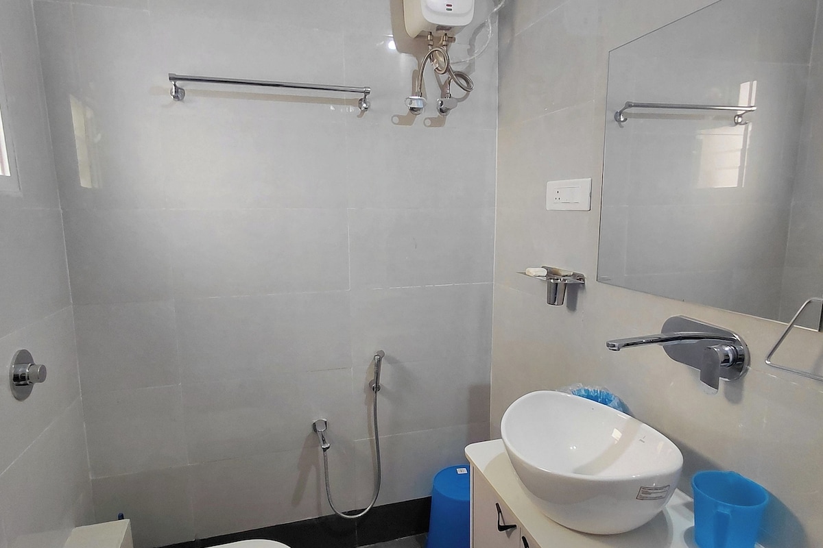 A modern bathroom with a toilet, sink, and shower.