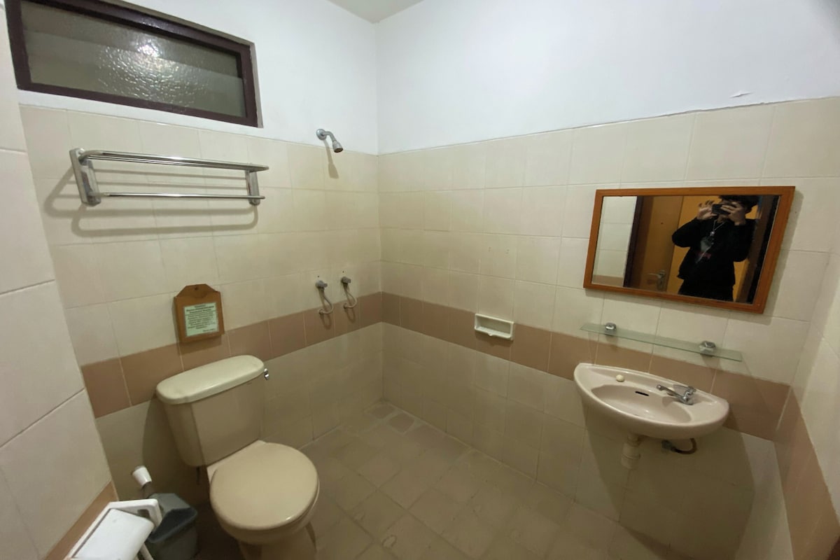 A small bathroom with a toilet, bidet, and sink.