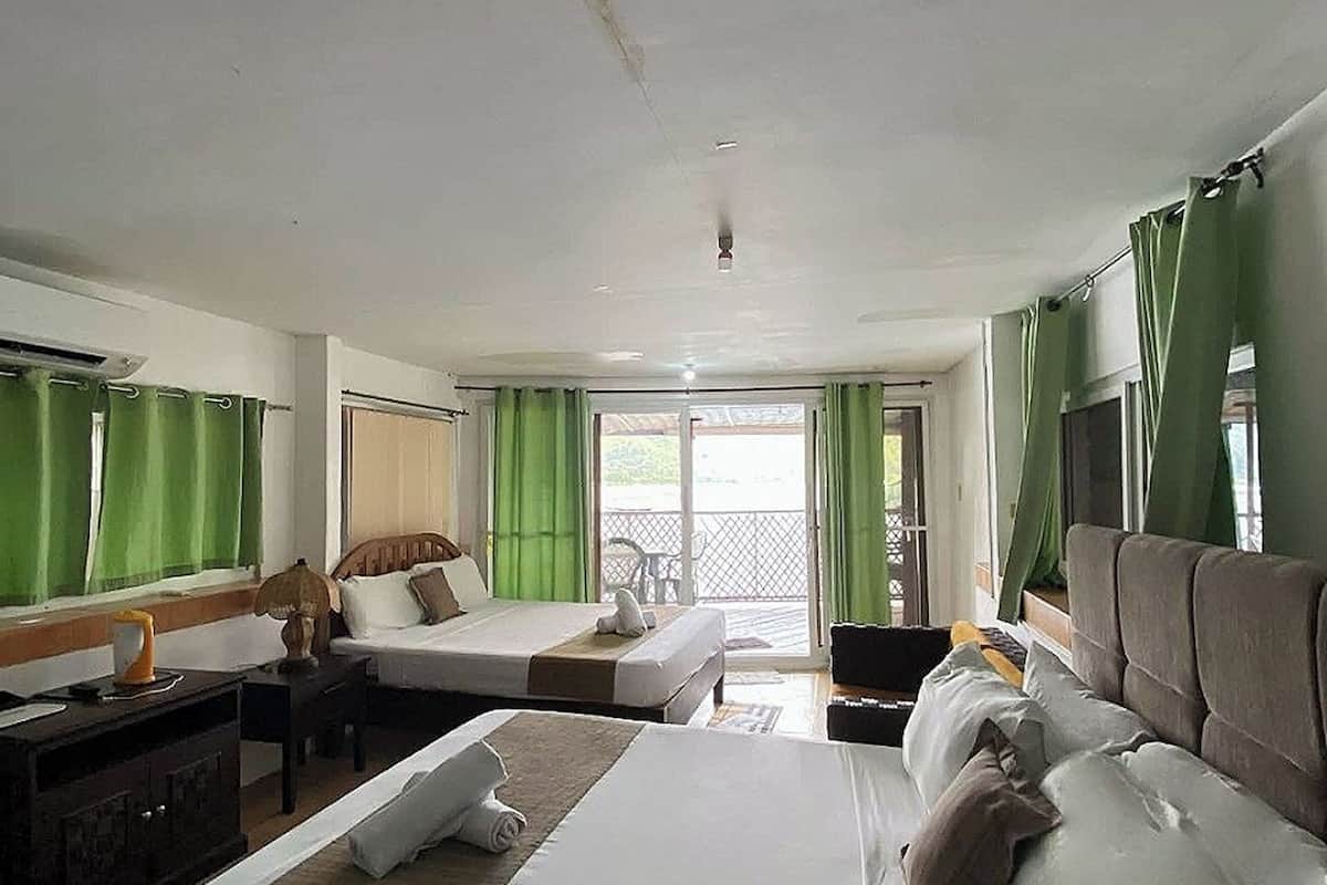 A hotel room with a large bed, a desk, a chair, and a view of the outdoors.