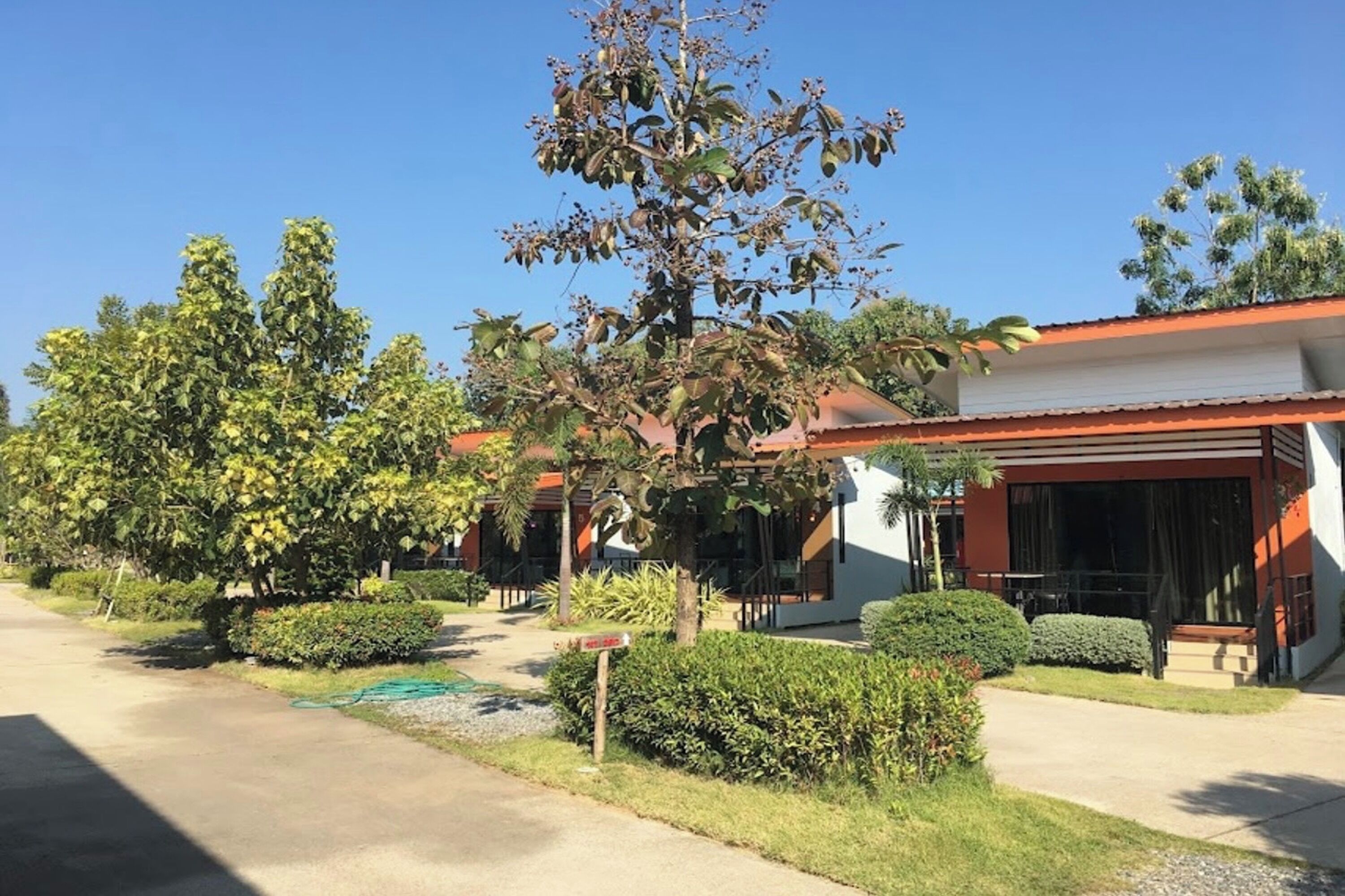 A residential area with a row of houses, each with a covered porch and a well-maintained lawn.