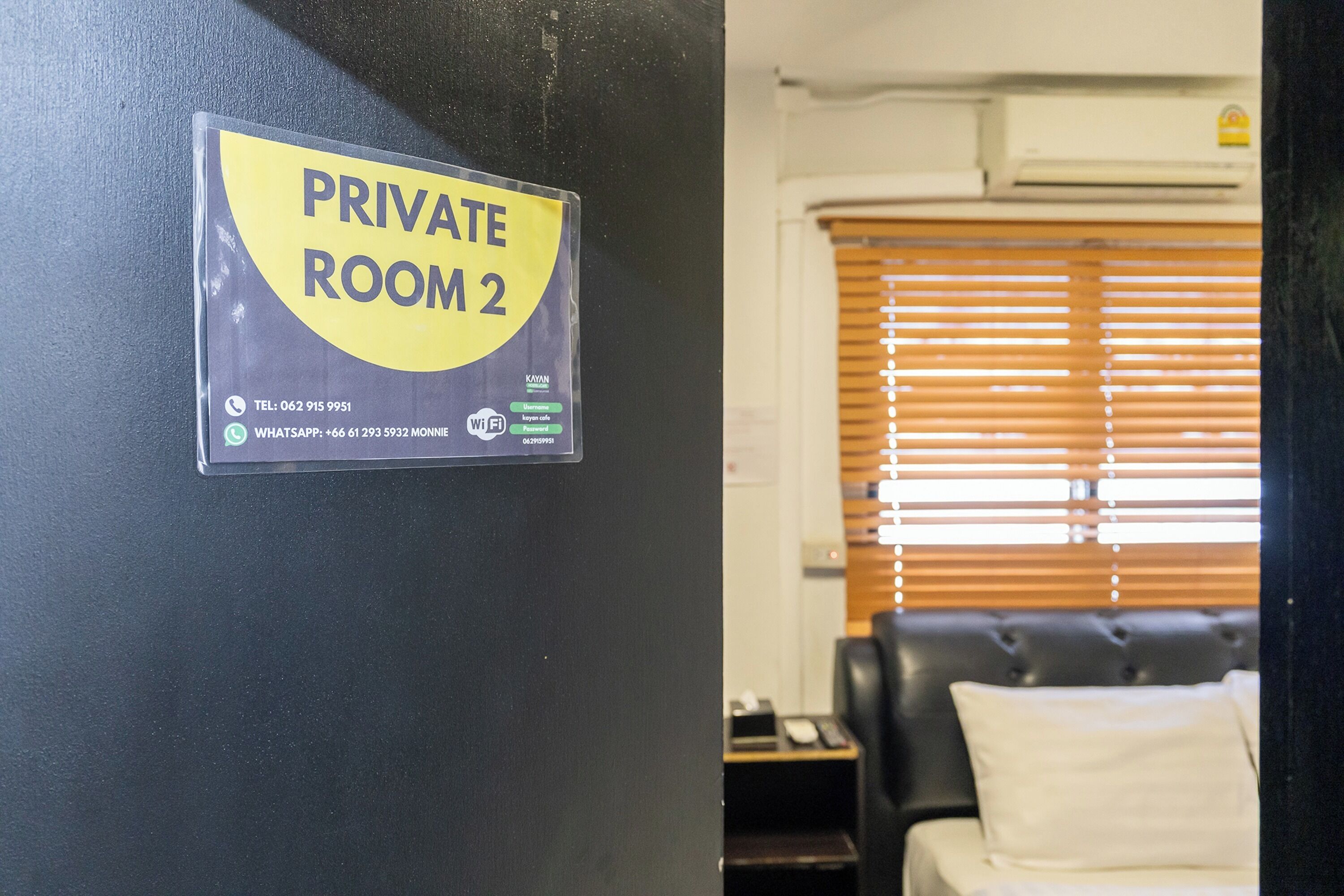 A sign indicating a private room with contact information and Wi-Fi details.