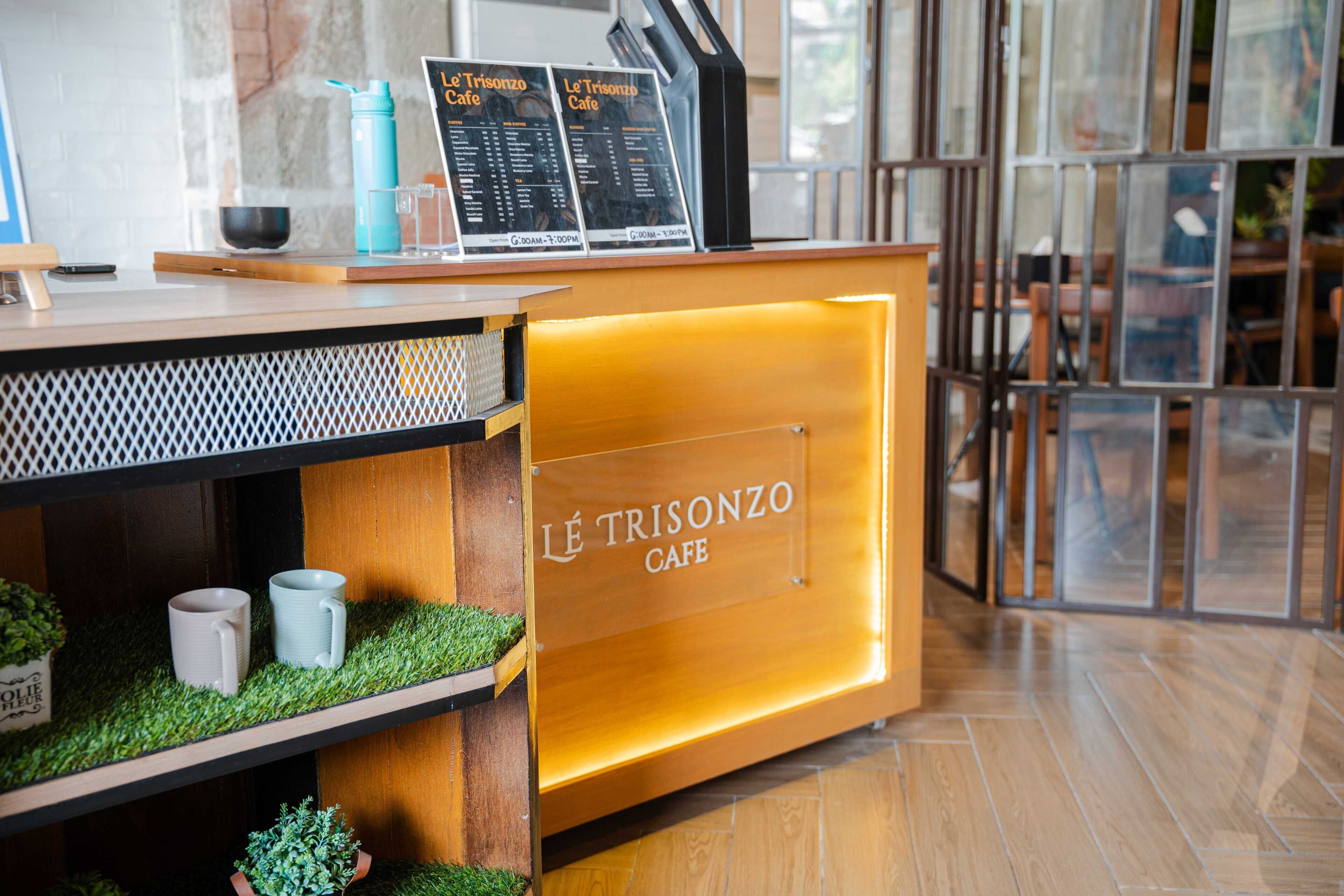 A café counter with a menu, a water bottle, and a glass.