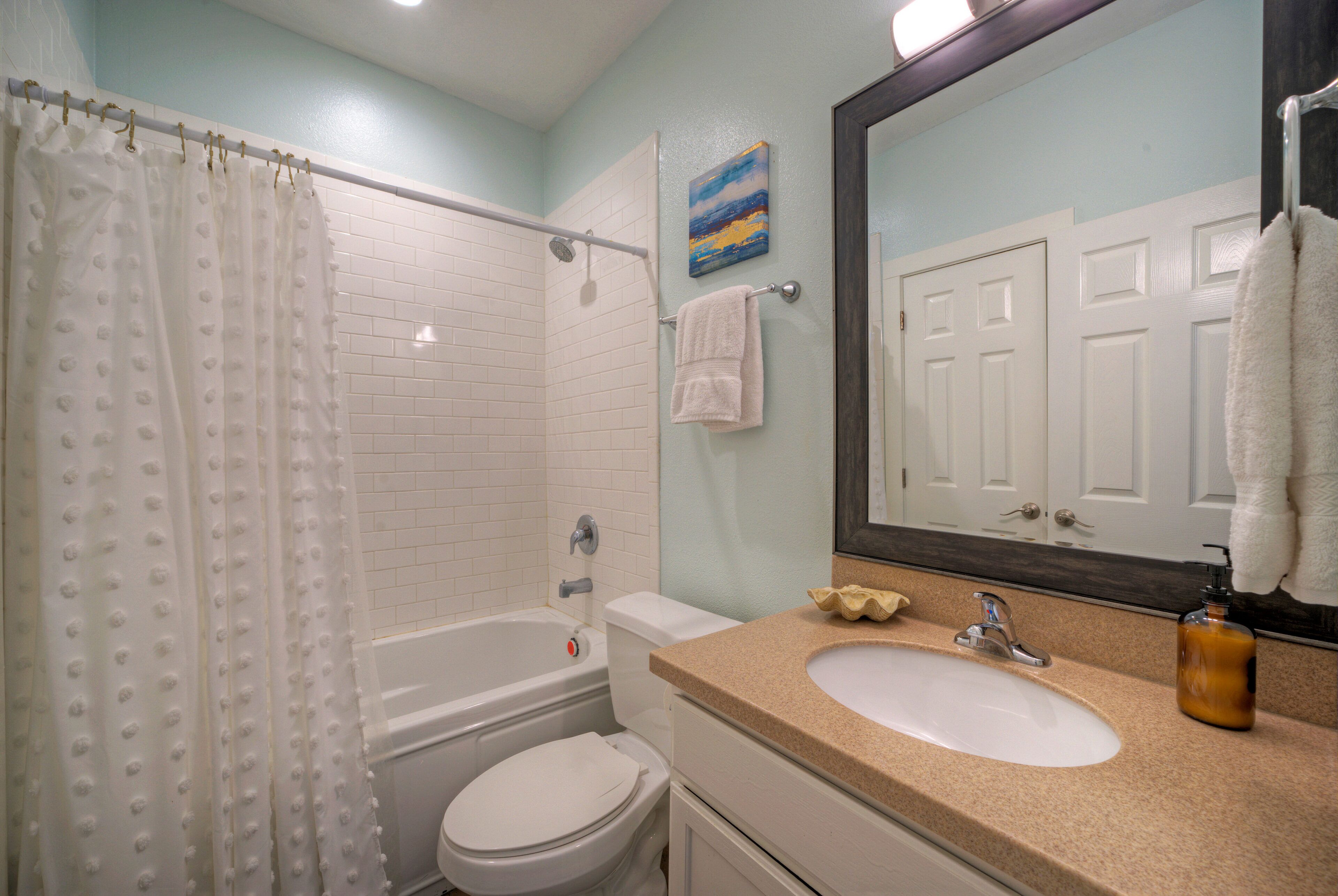 Ensuite bathroom 2 features shower tub combo (Unit 102)
