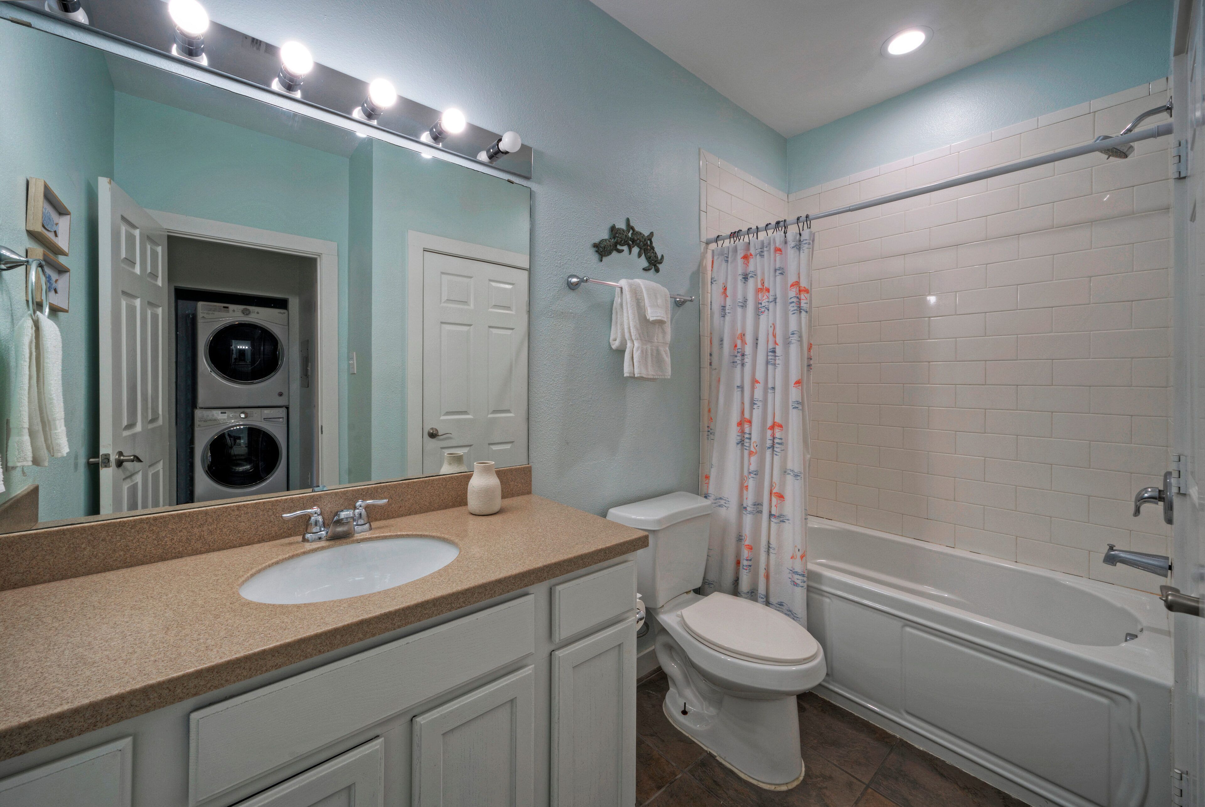 A bathroom with a sink, toilet, and bathtub.