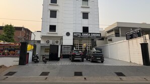A modern building with a sign for Hotel Ganga Greens and Restaurant (Pure Veg). - Hotel Ganga Greens (Lucknow)