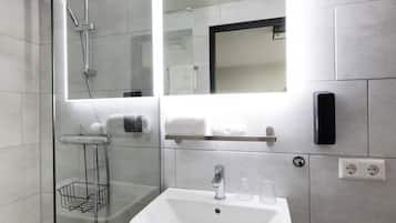 Standaard tweepersoonskamer | Badkamer | Een douche, handdoeken, zeep, shampoo