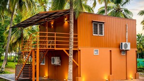 A two-story building with a staircase, an air conditioning unit, and a small window. - WINNERS HILL RESORTS (Coimbatore)