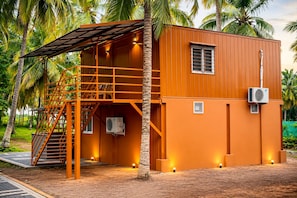 A two-story building with a staircase, an air conditioning unit, and a small window. - WINNERS HILL RESORTS (Coimbatore)