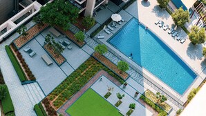 An aerial view of a modern hotel with a swimming pool, outdoor seating areas, and landscaped gardens. - 3Br + Maid Close To Burj Khalifa Dubai Mall (Dubai)