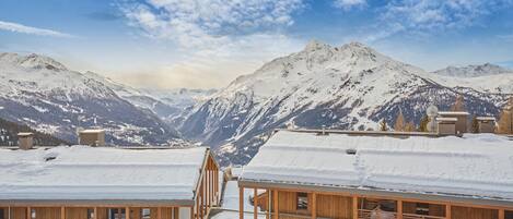A snow-covered mountain landscape with wooden cabins.