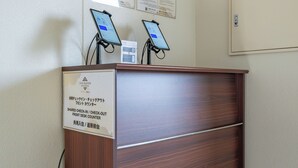 A wooden desk with a sign indicating a shared check-in/check-out counter at a hotel. - Stay Maison Hida Takayama (Takayama)