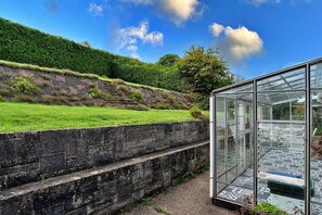Enjoy unobstructed views of the surrounding landscape from this sheltered conservatory.