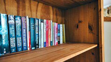 Uma estante de madeira com diversos livros.