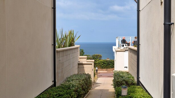 A narrow pathway leading to a balcony with a view of the sea. - Apartment in Carbis Bay with Stunning Sea Views (St Ives)