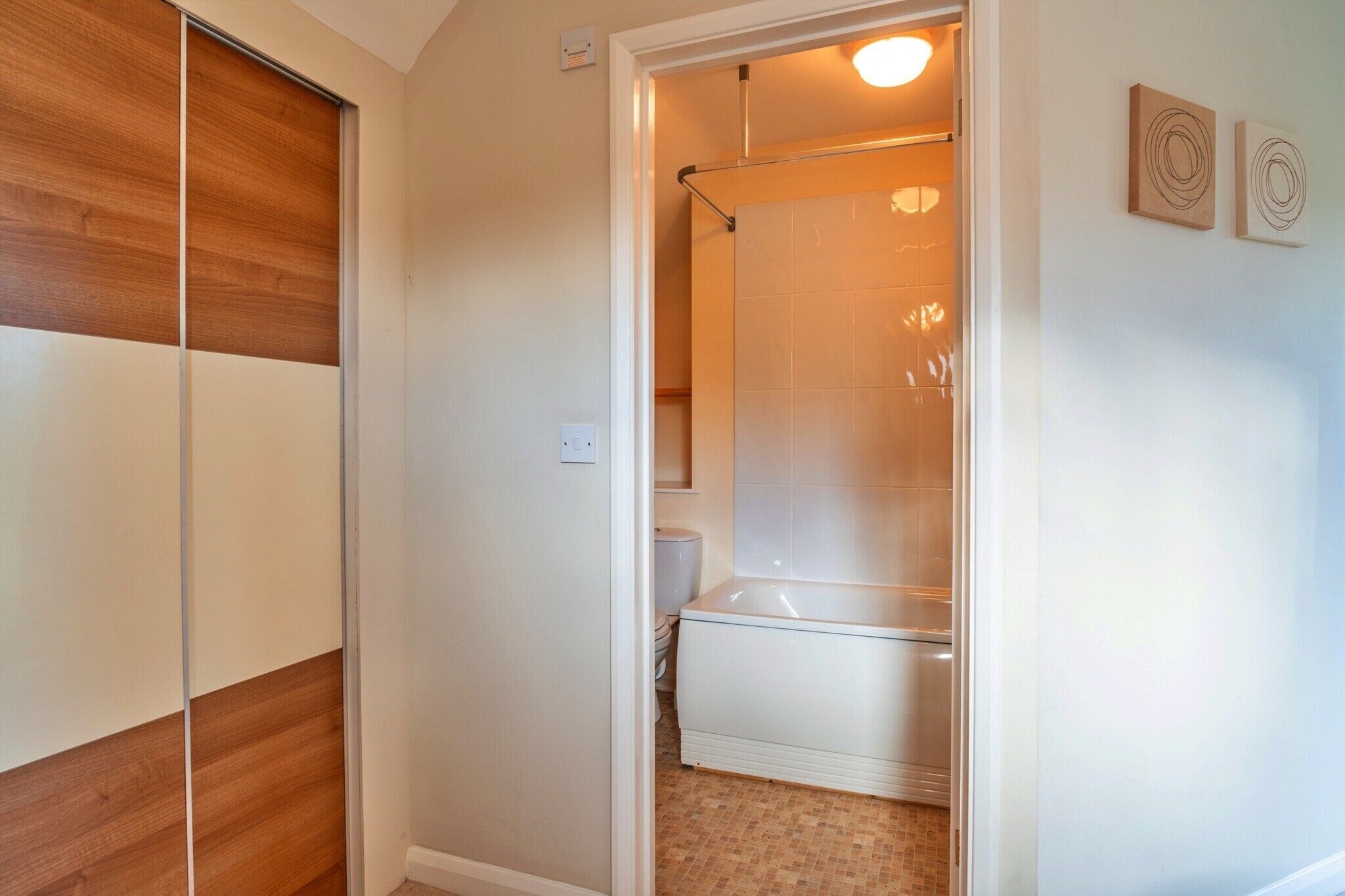 A bathroom with a shower, toilet, and a bathtub.
