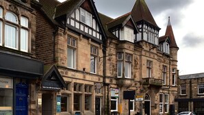 A historic building with multiple windows and a prominent tower. - Apartment in Matlock near Peak District Trails (Matlock)