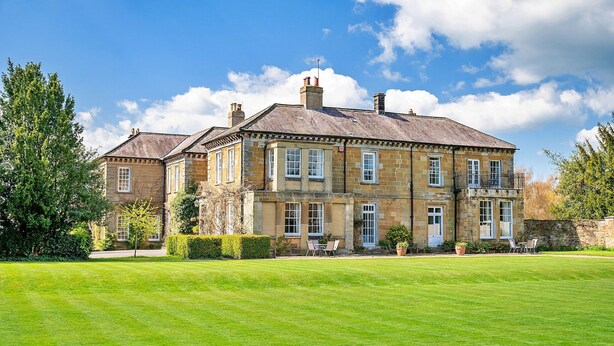 A large, two-story stone building with a well-maintained lawn in front. - Lodge in Thirsk with Spa & Scenic Trails (Thirsk)