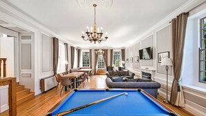A spacious room with a pool table, a sofa, and a dining area. - Lodge in Thirsk with Spa & Scenic Trails (Thirsk)