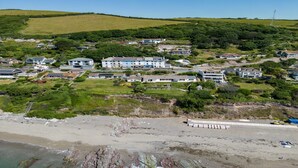 A coastal area with a mix of residential buildings and a beach.