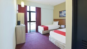 A hotel room with two beds, a desk, a chair, a window with curtains, and a painting on the wall. - Hotel O Cozy Fox Hotel (Petaling Jaya)