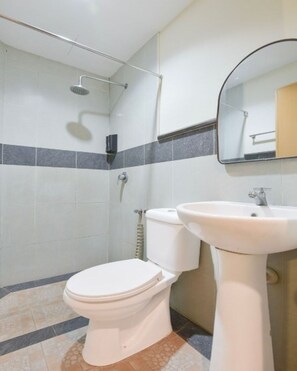 A bathroom with a toilet, sink, shower, and a mirror. - Hotel O Cozy Fox Hotel (Petaling Jaya)