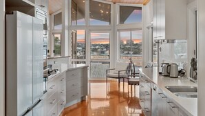 Una cocina moderna con ventanas amplias, un comedor y vistas a la ciudad.