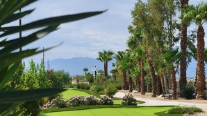 A well-maintained golf course with a sign indicating 'Bacchus Lakes'. - Coachella Lakes RV Resort (Coachella)