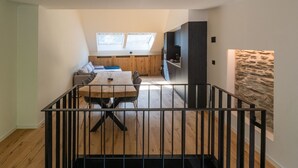 A modern loft apartment with a dining area, kitchen, and living space. - Holiday Home in La Roche with Castle Views (la roche-en-ardenne)