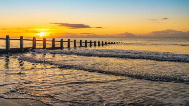 A wooden pier extending into calm waters at sunset. - Cottage in Dartmoor with Private Hot Tub (Bovey Tracey)