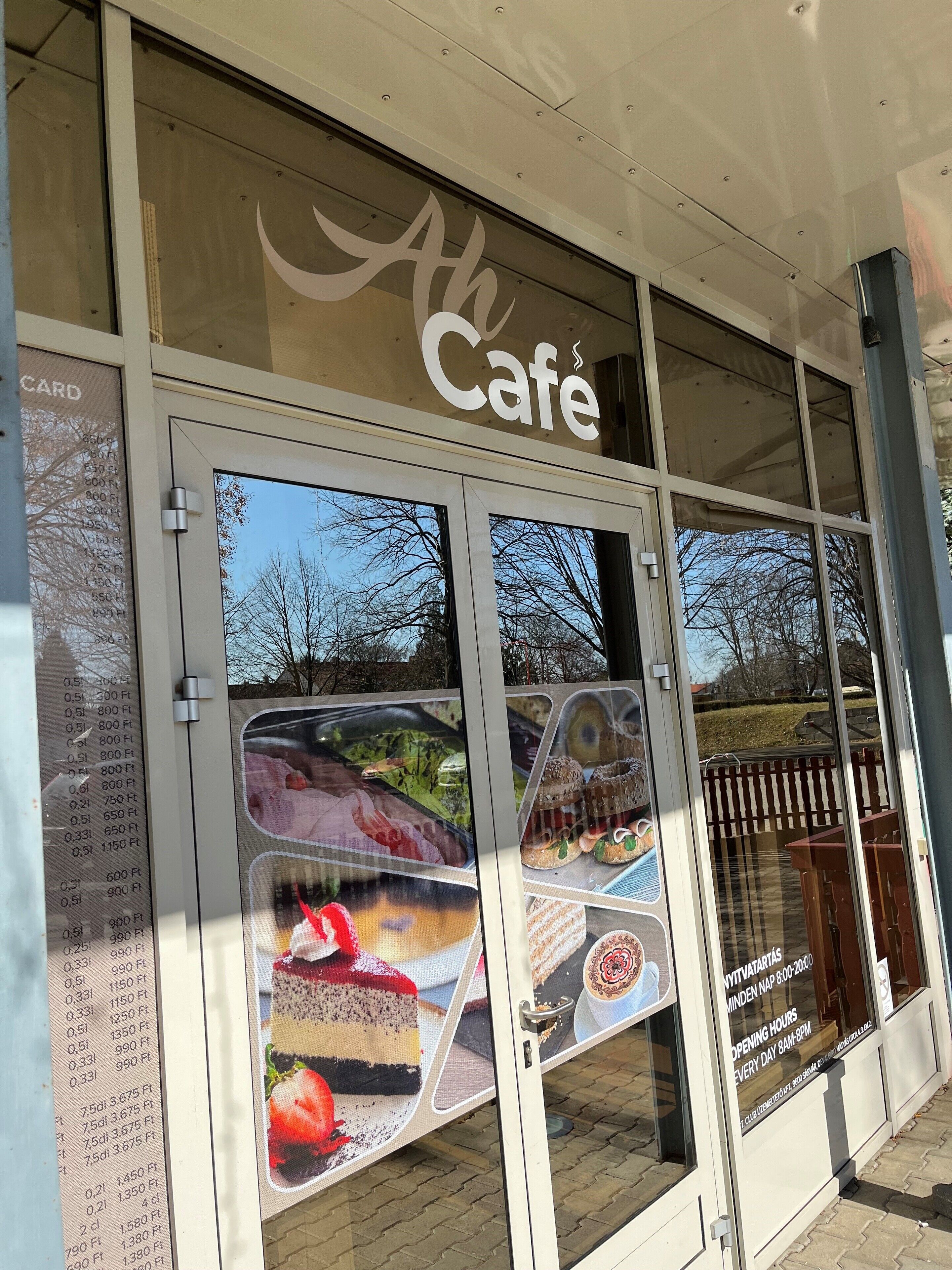 A storefront with a large glass door and windows displaying various food items.
