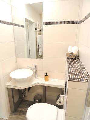 A bathroom with a white sink, mirror, and toilet. - Apartment 'Karins Pension Room 4' with Wi-Fi (Lampertheim)